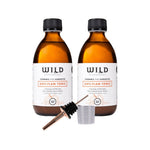 Two bottles of Anti-Flam Tonic with a tonic pourer and a 20ml plastic measuring cup on a white background.