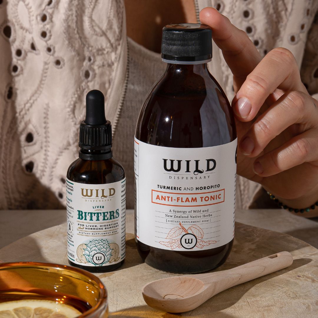 Woman holding Anti-Flam next to Liver Bitters
