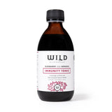 A bottle of elderberry and mânuka Immunity Tonic, featuring a dark amber glass bottle, black cap, and a white label with red and black text, set against a plain white background.