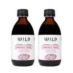 Two amber glass bottles of elderberry and mânuka Immunity Tonic with black caps and white labels, shown side by side on a white background.